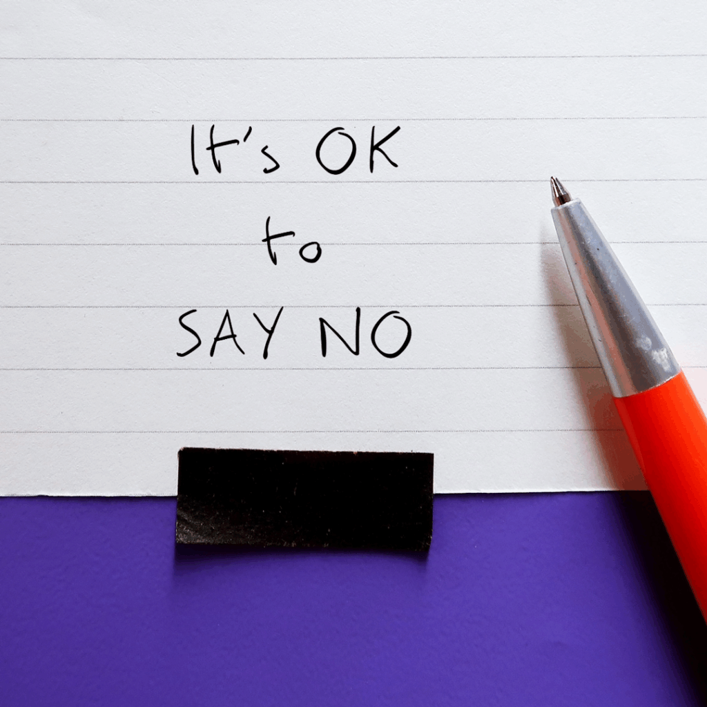 Pen and note card that has "It's okay to say no" written on it