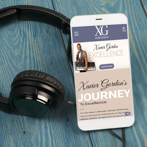 Xavier Gordon music website on cellphone next to headphones